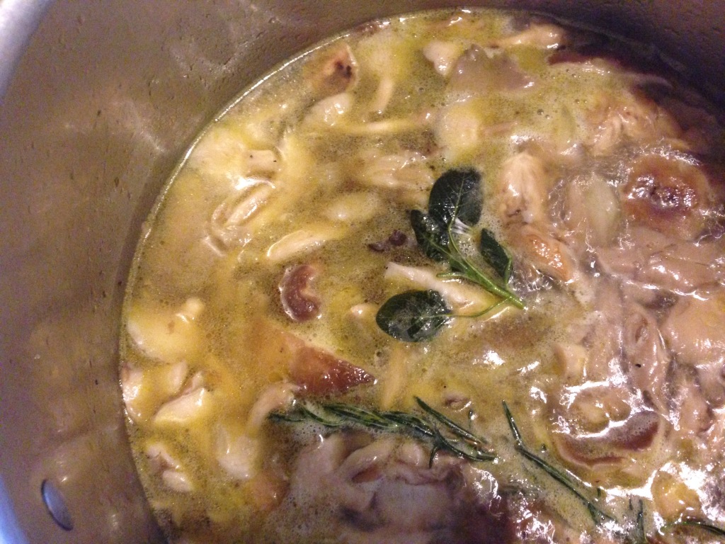 mushrooms and herbs simmering in broth